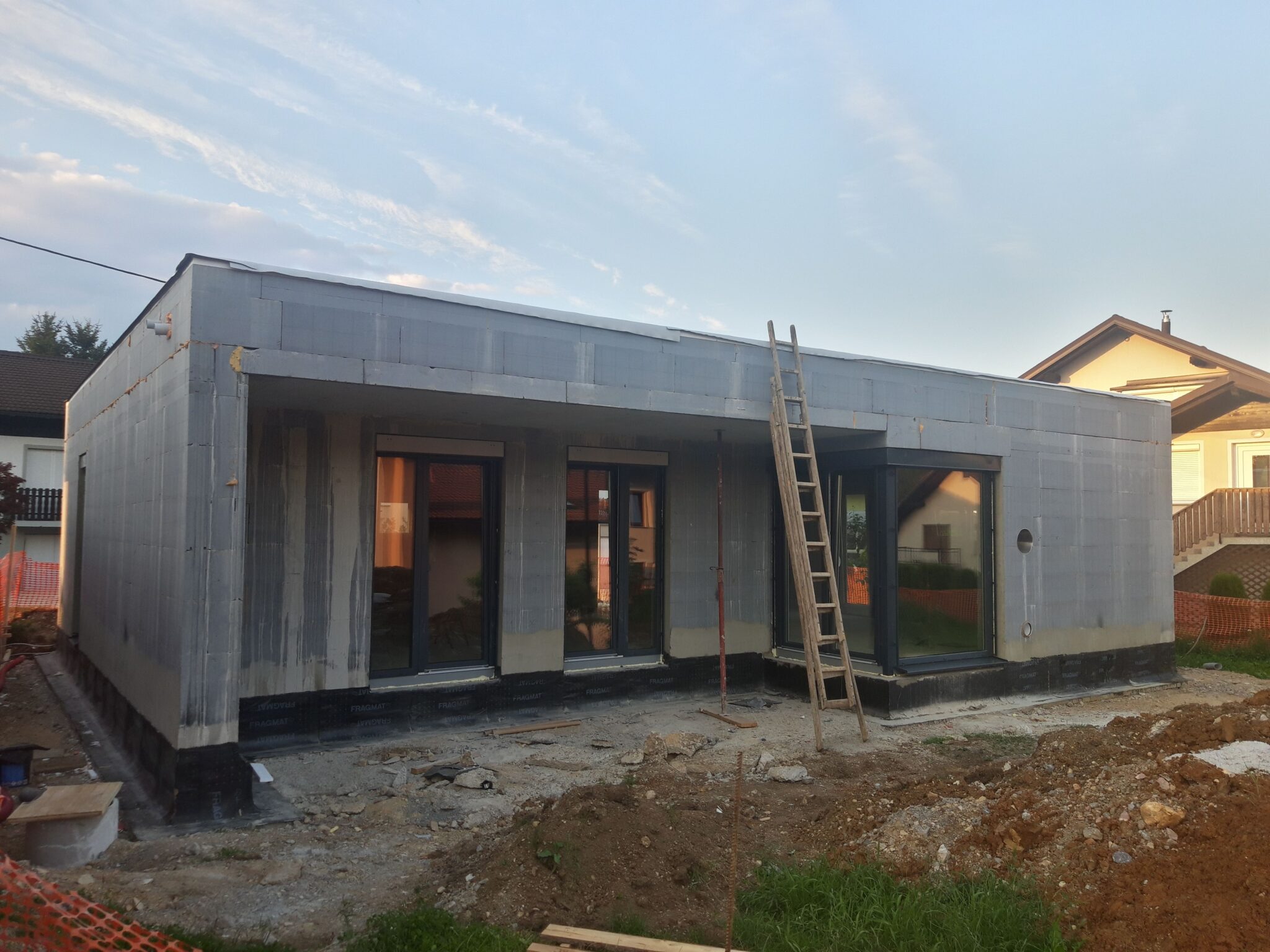 Zaključena gradbenih del enostanovanjske hiše z ravno streho v Trebnjem. Na sliki hiša pred izvedbo fasade.